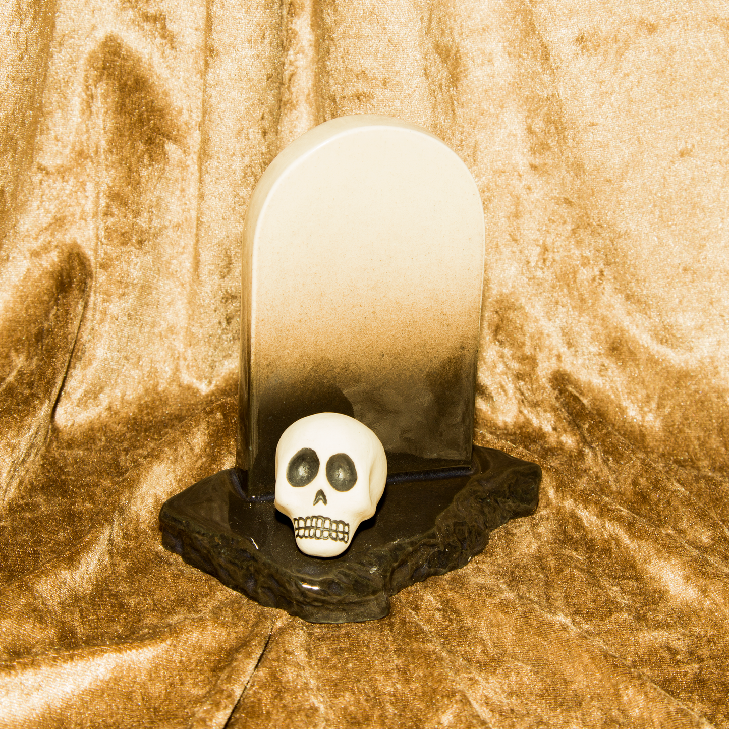 Gravestone and skull sculpture